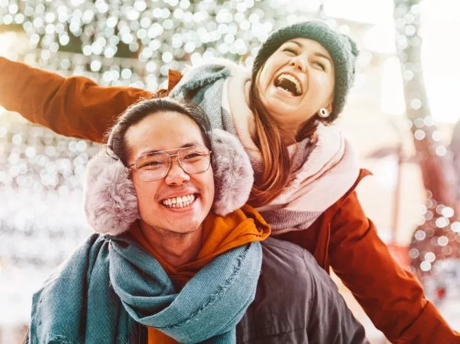 Man and woman under winter lights