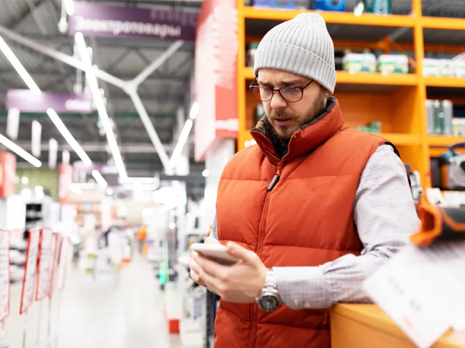 Man at store looking at phone