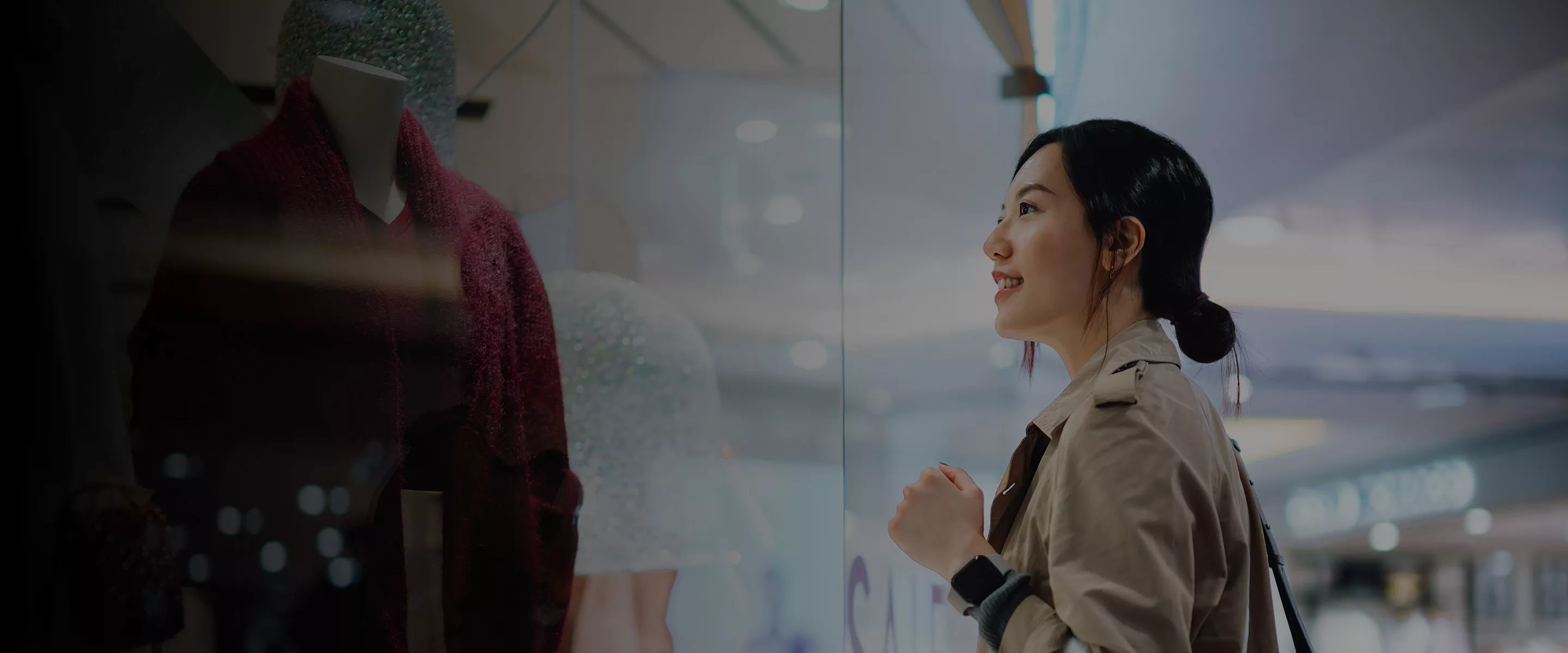 Woman looking at clothing in mall banner