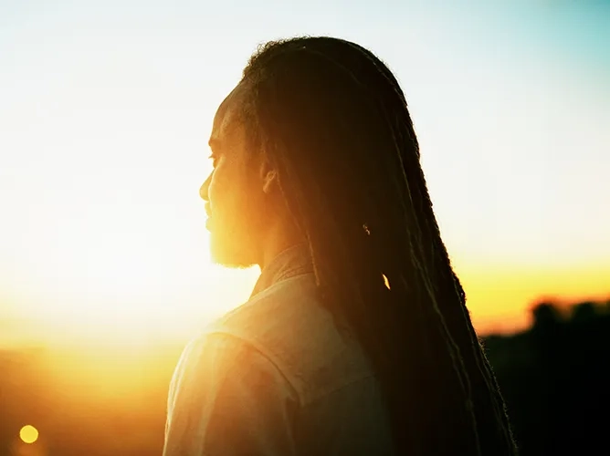 Woman looking into the sun teaser